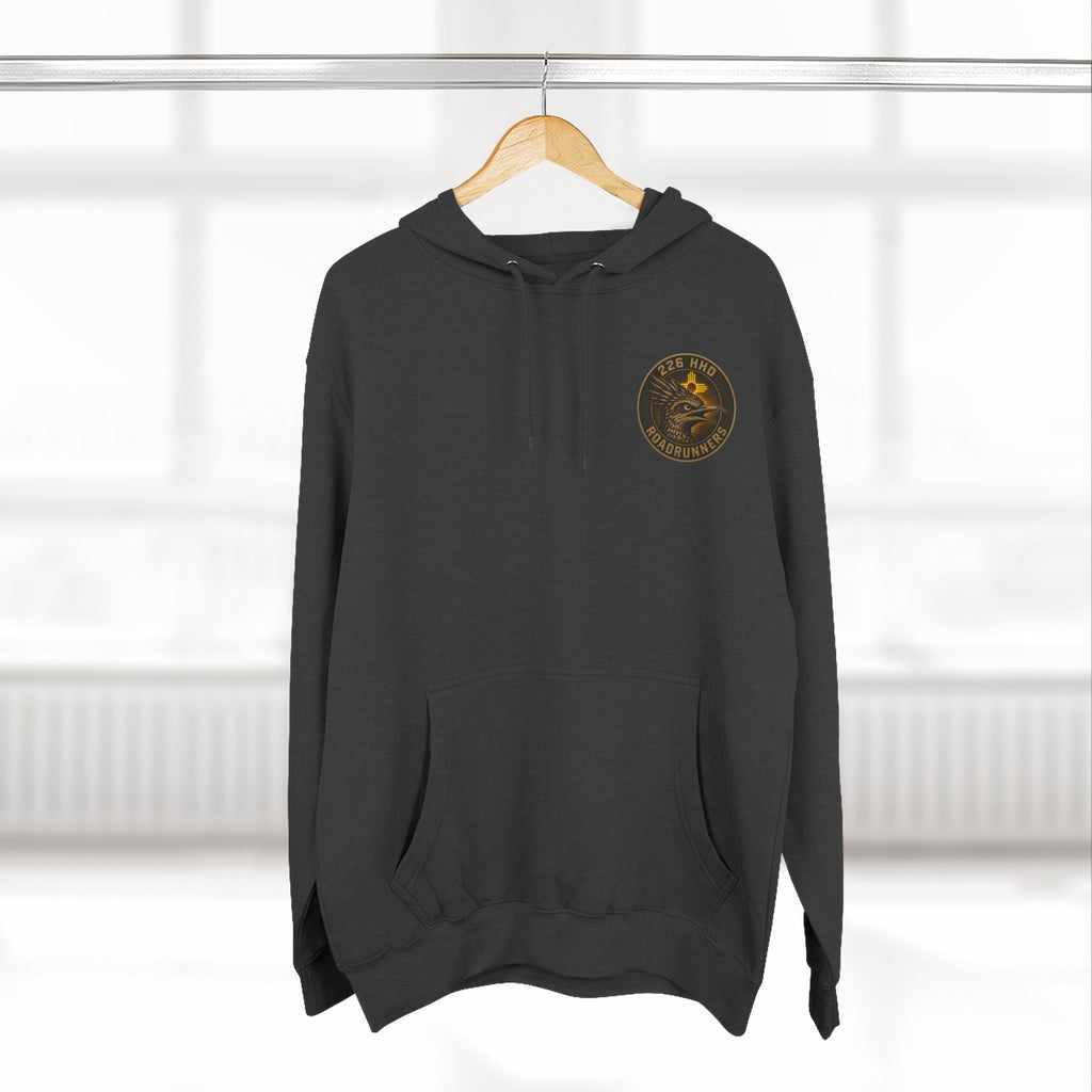 Black pullover hoodie hanging on a hanger with hood and front kangaroo pocket