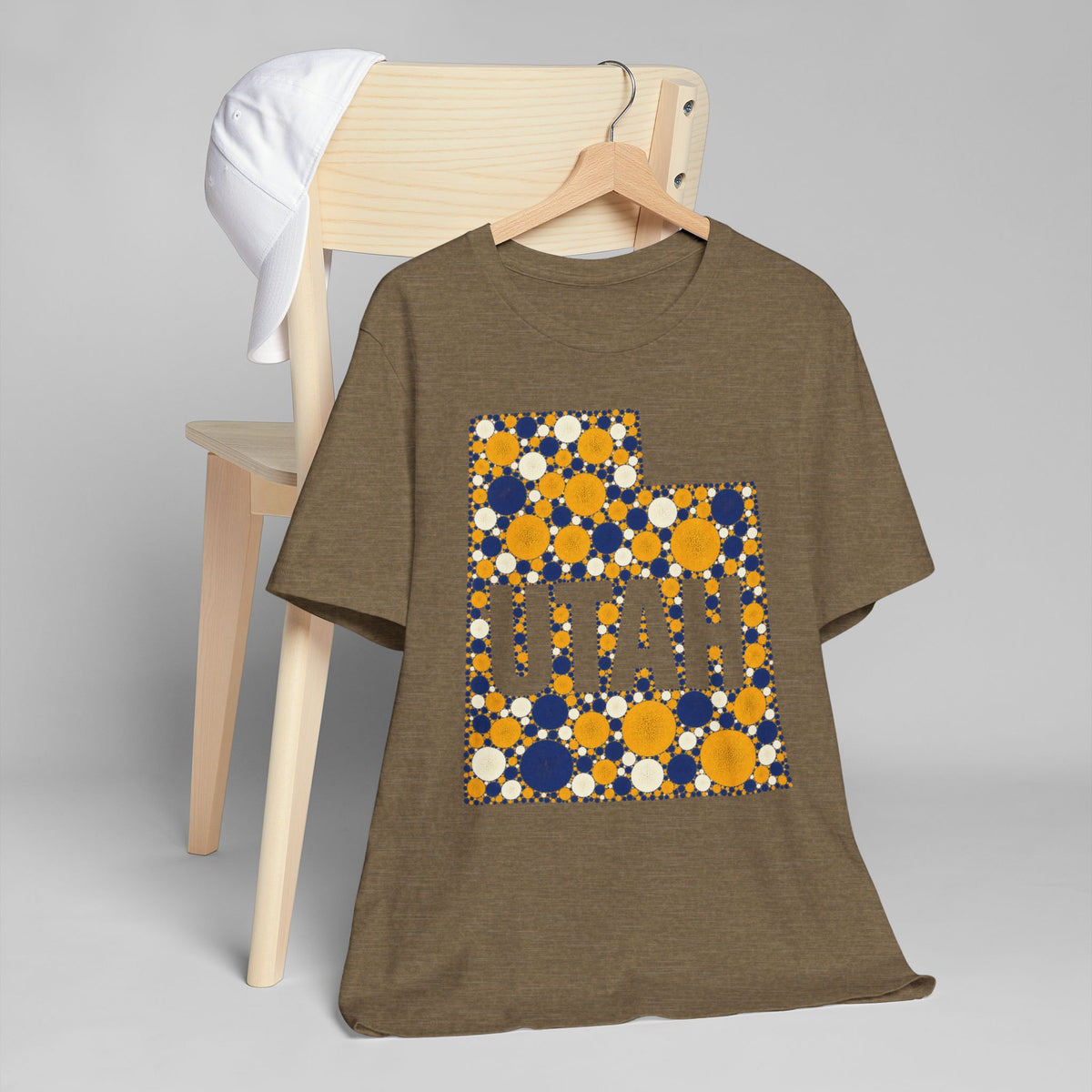 Brown T-shirt with blue and gold polka-dot Utah map outline and lettering graphic