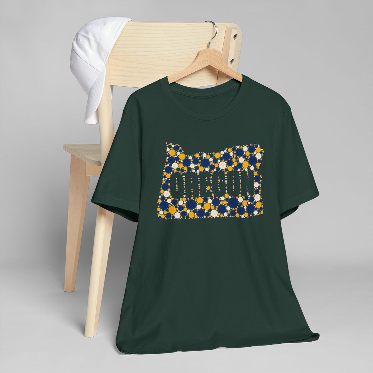 Forest green crewneck t-shirt with Oregon graphic in blue and gold dots