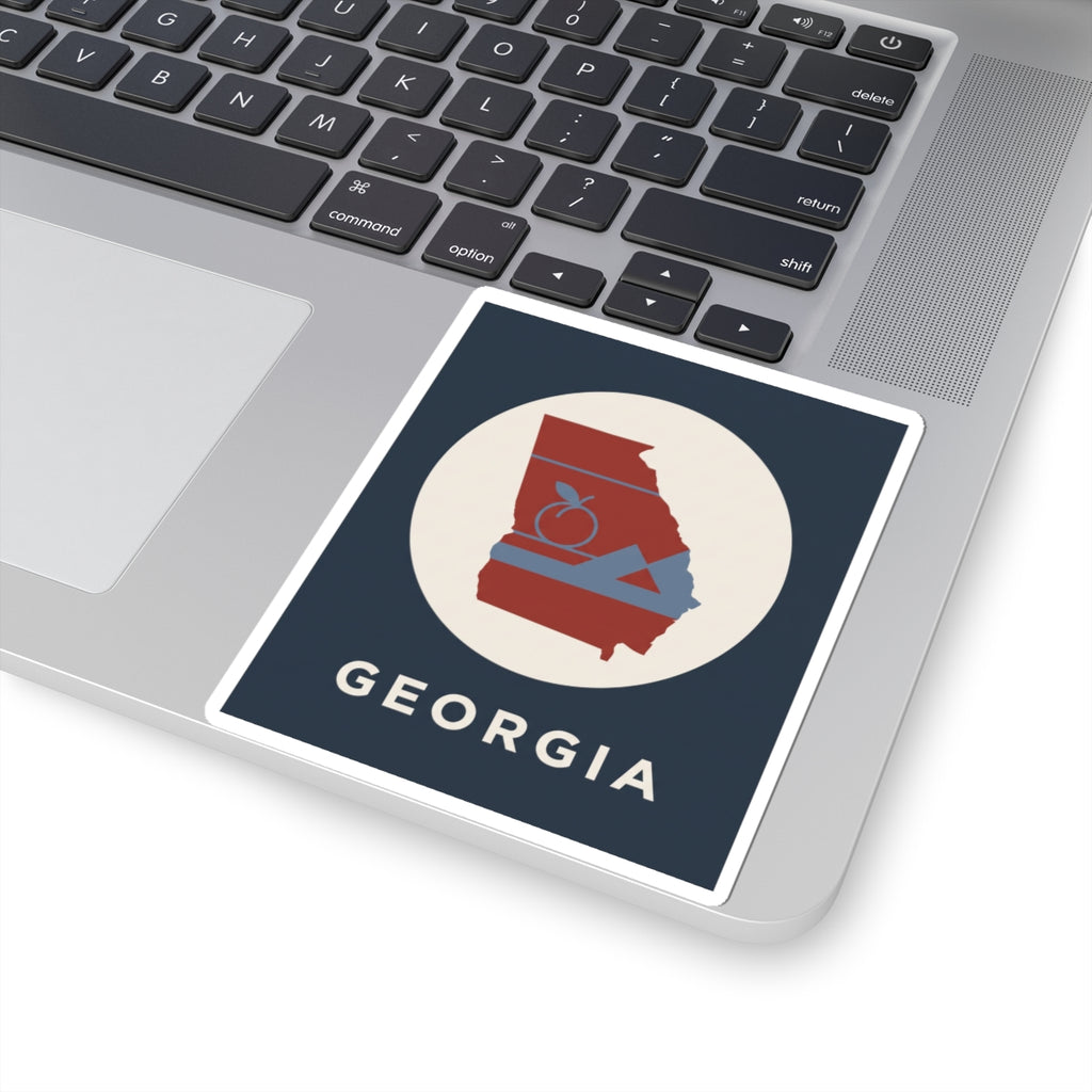 Georgia outline sticker on laptop screen: red state with peach icon and mountains, “GEORGIA”