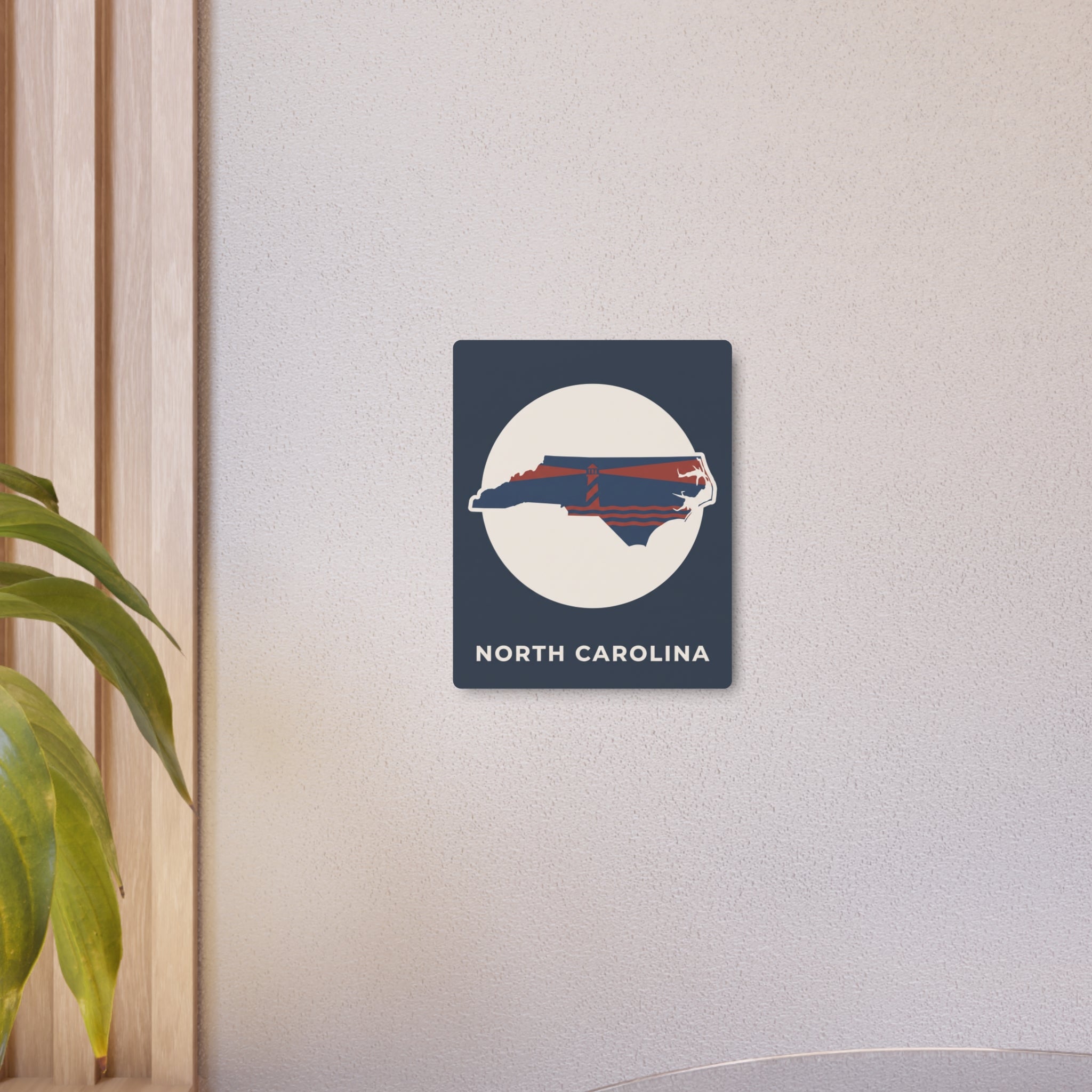 North Carolina metal art sign with circular emblem and state lighthouse graphic
