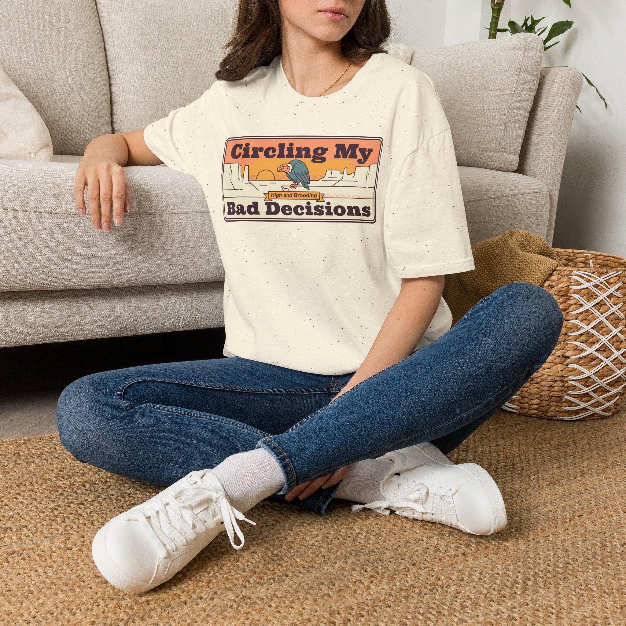 Cream crew-neck T-shirt with centered “Circling My Bad Decisions” graphic