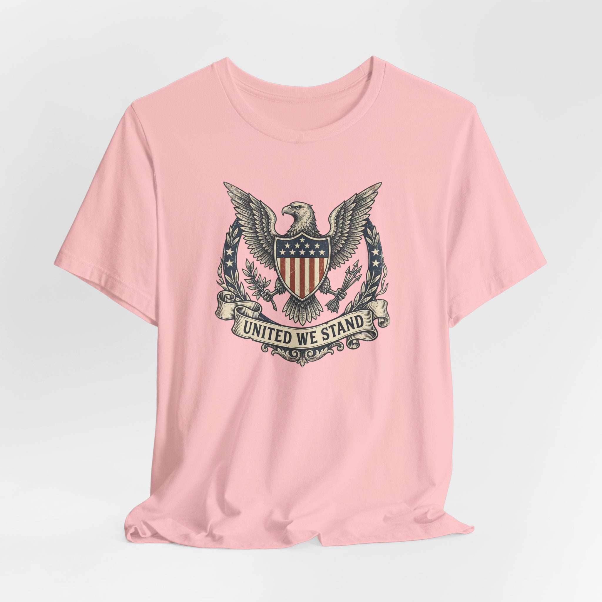Light pink T-shirt with centered eagle shield crest and “United We Stand”