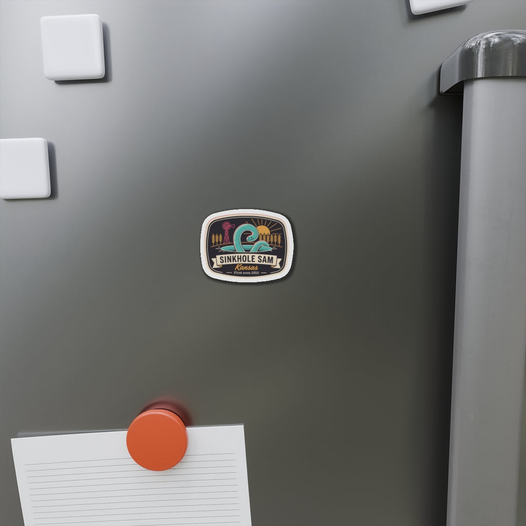 Die-cut sticker-style magnet on a refrigerator door, oval Kansas scenic artwork