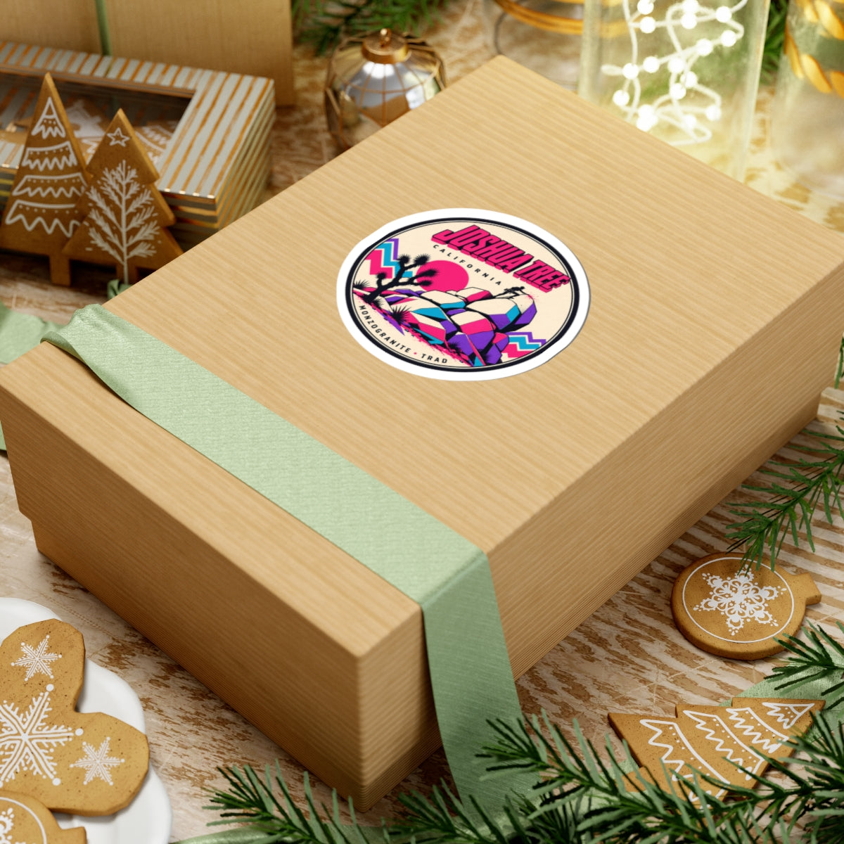 Round vinyl sticker on gift box lid, multicolor desert rocks and Joshua tree design.
