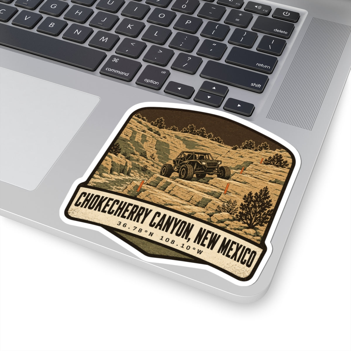 Die-cut sticker angled view, desert canyon off-road vehicle graphic with 'Chokecherry Canyon, New Mexico'