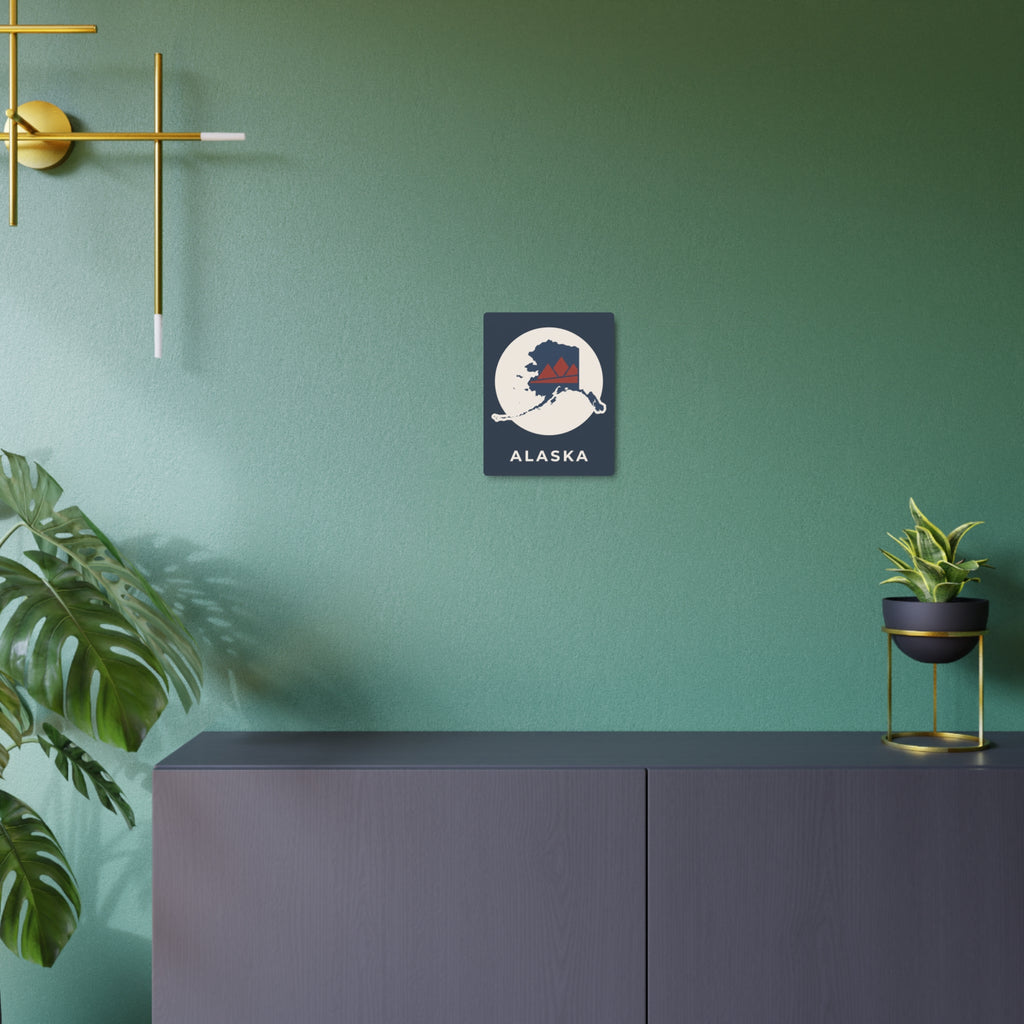 Alaska metal art sign on wall, dark blue square with circular map and red mountains