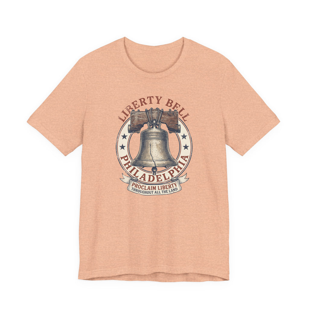 Peach T-shirt with Liberty Bell graphic emblem at center chest