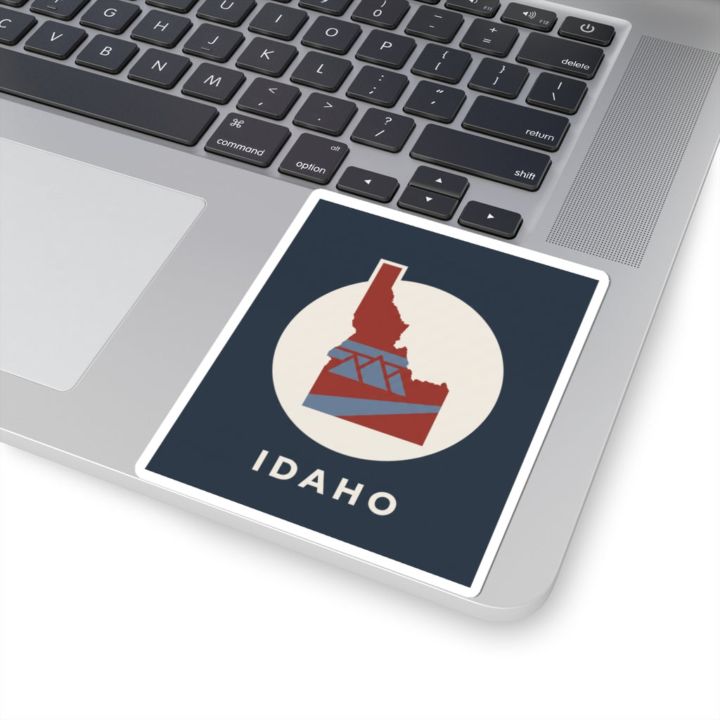 Idaho kiss-cut sticker featuring red state-and-bridge design in a white circle, IDAHO