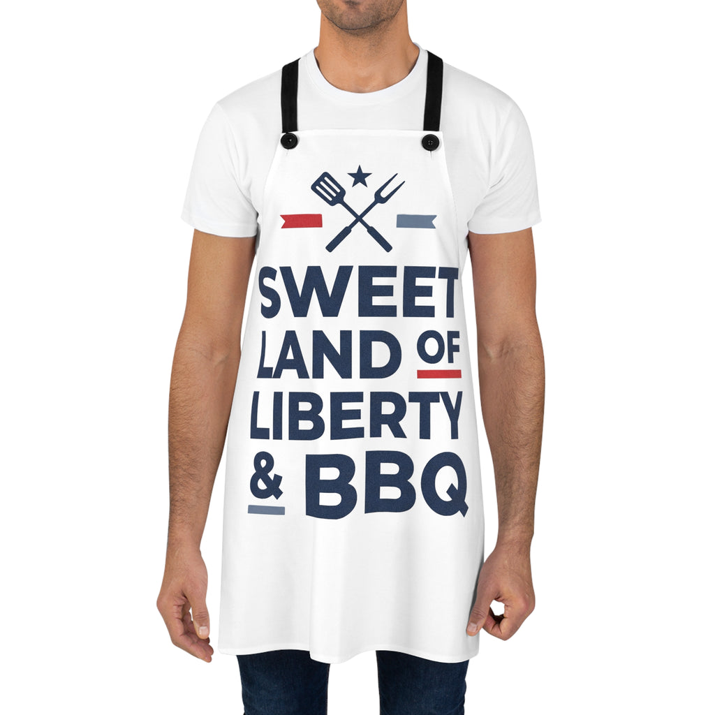 BBQ apron worn by a man, white fabric with black straps and large patriotic lettering