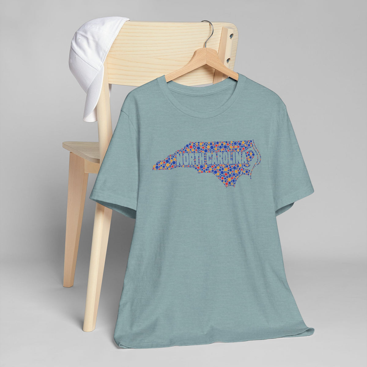 Teal crew-neck T-shirt with colorful North Carolina floral map graphic