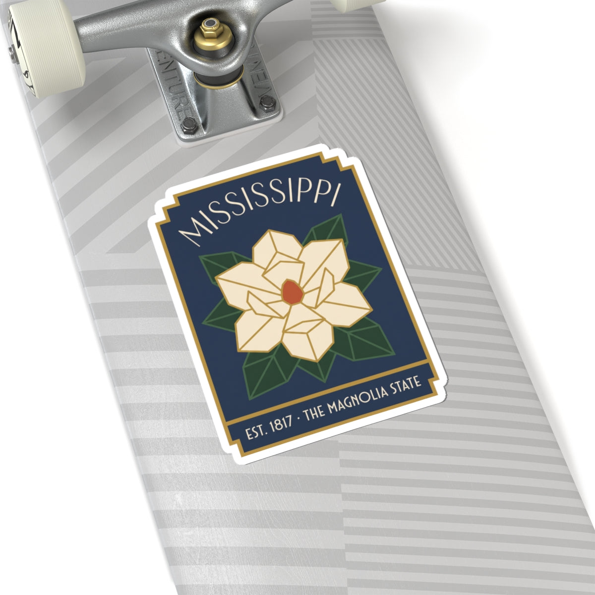 Kiss-cut vinyl sticker on gray surface with Mississippi text and magnolia bloom