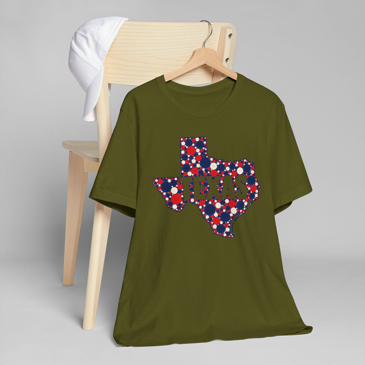 Olive green T-shirt with polka-dot Texas outline graphic in red, white, and blue