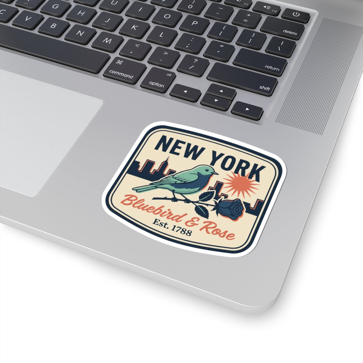 NEW YORK bluebird & rose vinyl sticker on a laptop keyboard surface