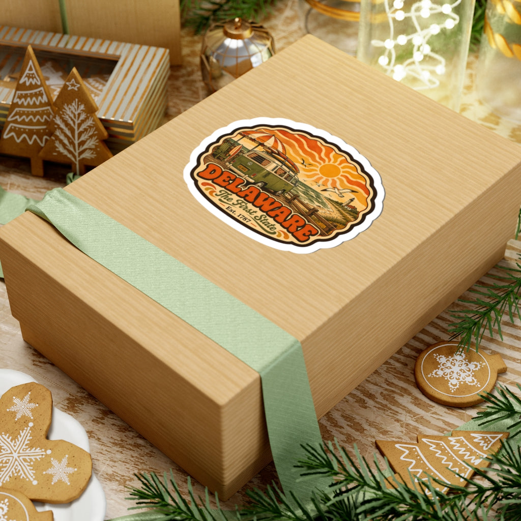 Delaware oval decal on wrapped gift box, with vintage green van and orange sun artwork