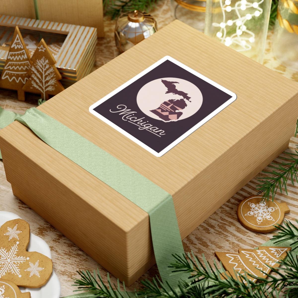 Michigan kiss-cut decal on a gift box: cream circle, purple lighthouse buildings, and “Michigan” script.