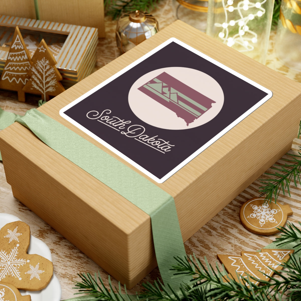 South Dakota kiss-cut decal on a wrapped gift, dark purple design with cursive lettering