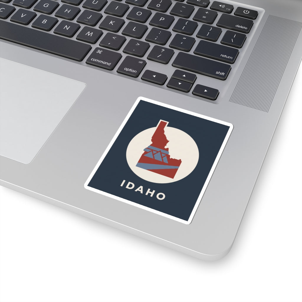 Square kiss-cut Idaho sticker with blue field, white circular frame, and red emblem