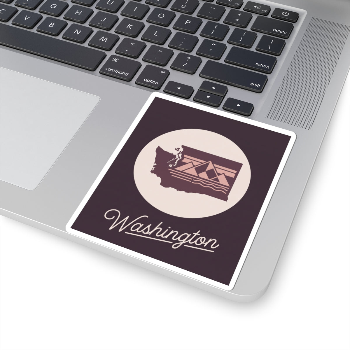 Washington state decal on a laptop lid, circular emblem with "Washington"