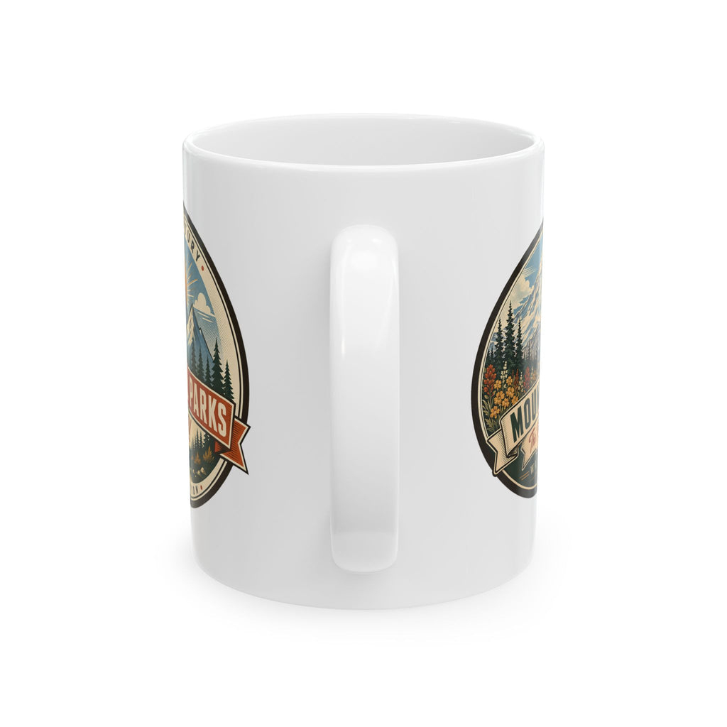 White ceramic mug showing front side Mount Rainier emblem and handle opening