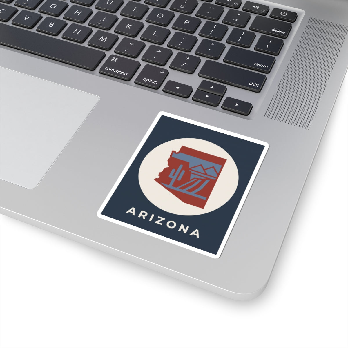 Arizona sticker on laptop, square border with cactus desert icon and “ARIZONA”