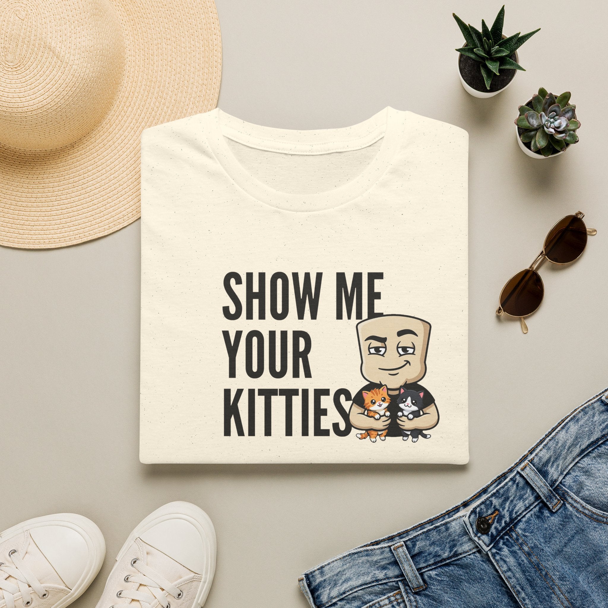 White graphic t-shirt with text 'SHOW ME YOUR KITTIES' and cat illustration