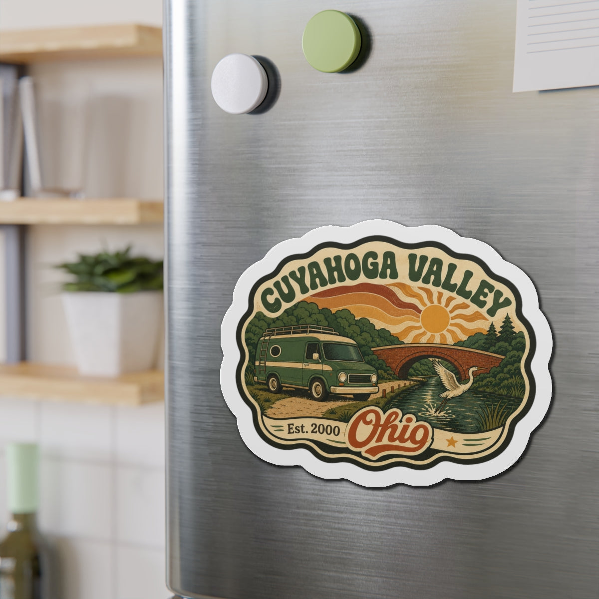 Die-cut Cuyahoga Valley fridge magnet showing green camper van over river landscape