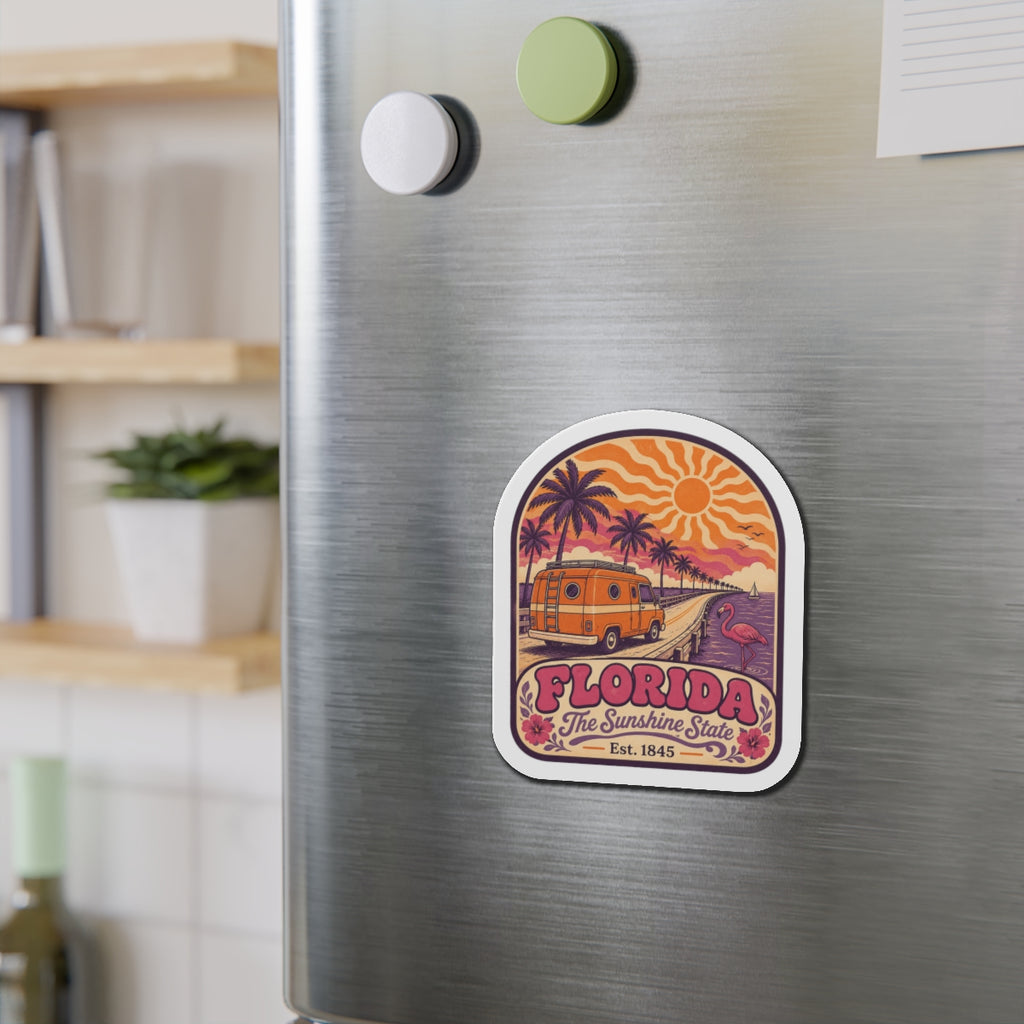 Florida-themed die-cut magnet with vintage van, palm trees, and flamingo on metal surface