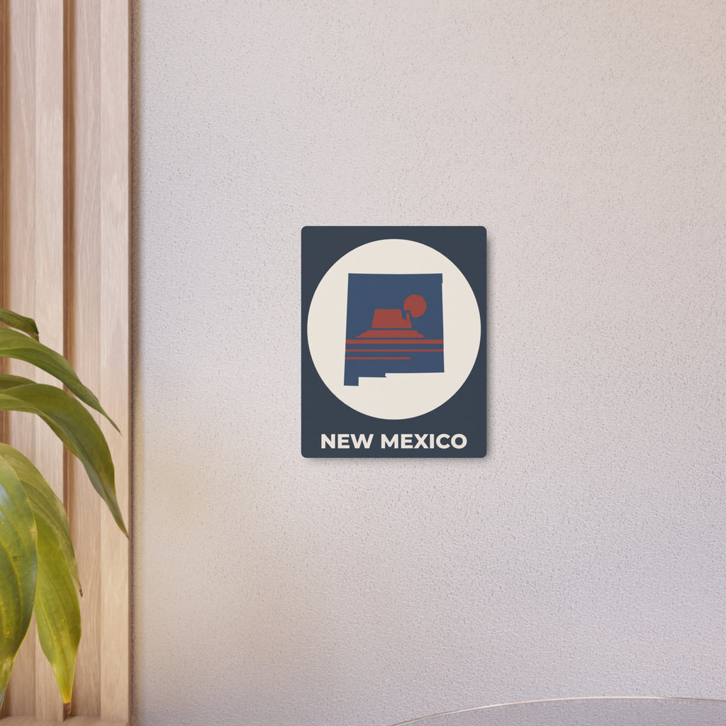 New Mexico metal wall sign, dark blue square with white oval and red sunset mesa silhouette