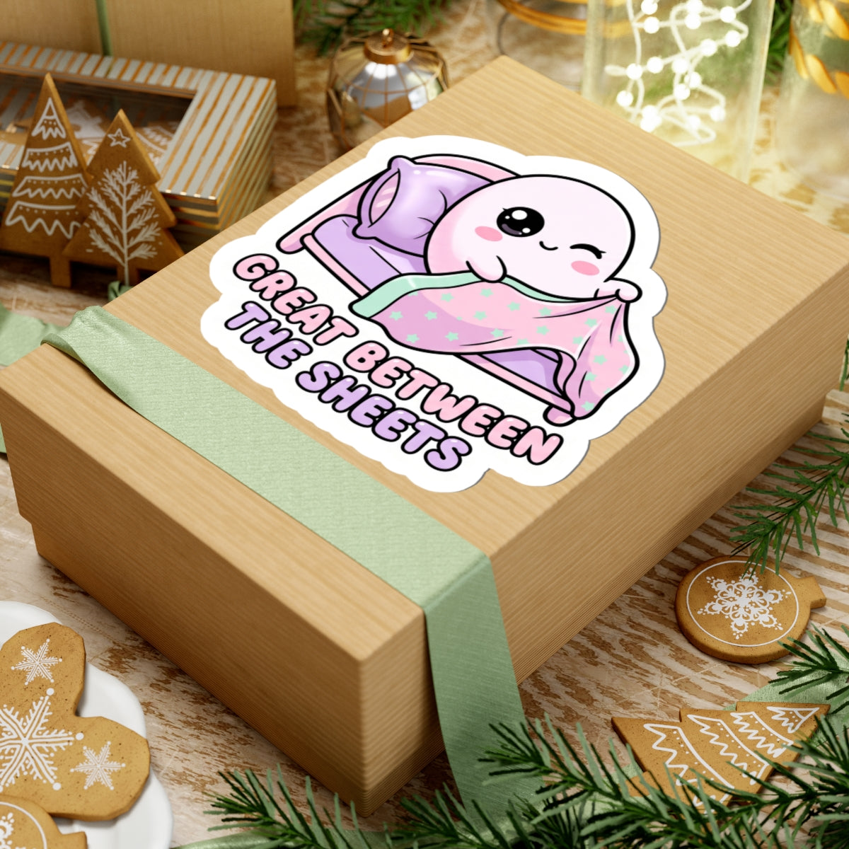 Kiss-cut sticker on gift box: kawaii ghost in mint star blanket on purple bed, “GREAT BETWEEN THE SHEETS”