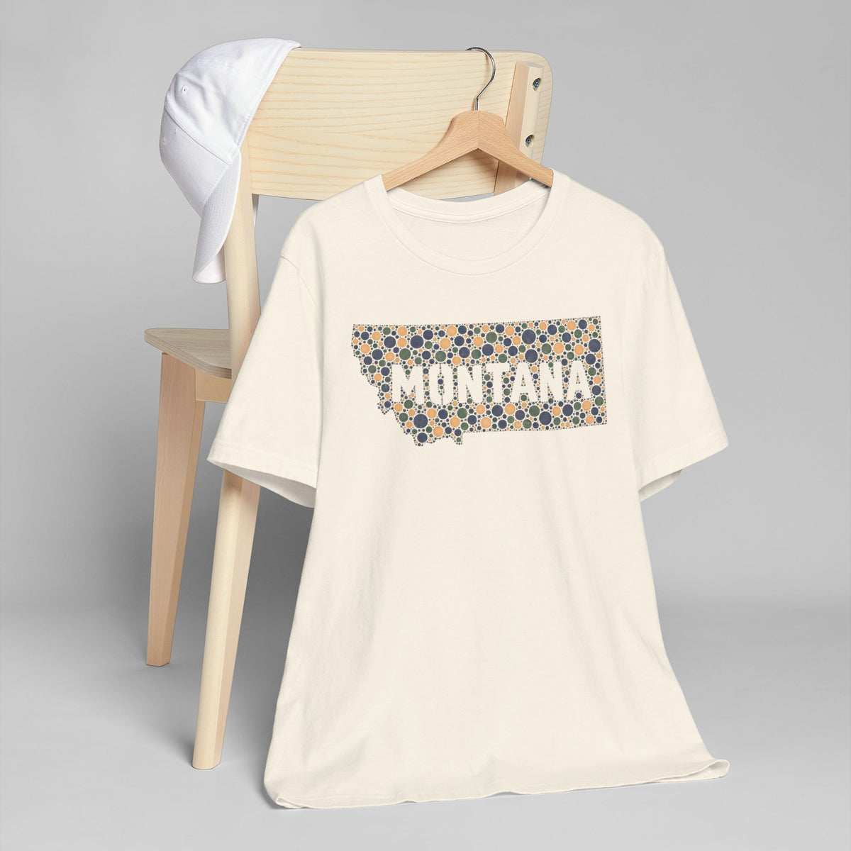 Cream crewneck t-shirt with colorful patterned “MONTANA” graphic on front