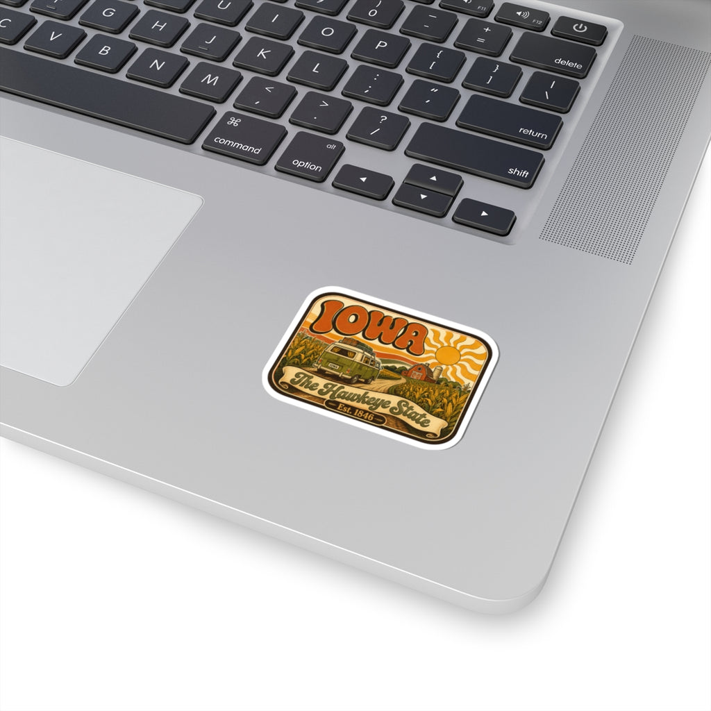 Iowa retro roadtrip camper kiss-cut sticker, orange and yellow design on white laptop