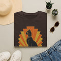 Dark brown T-shirt with black Egyptian cat wearing headdress, orange sunburst graphic.