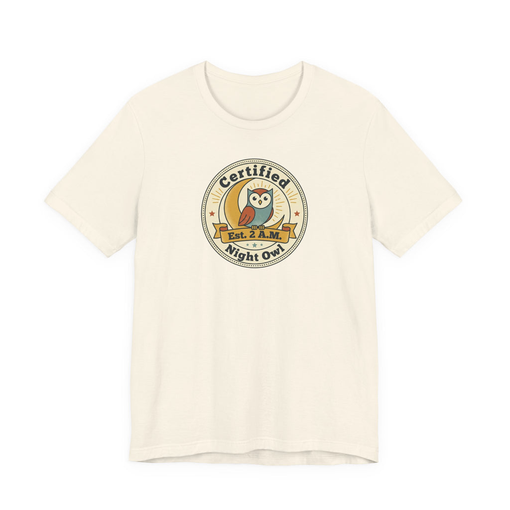 Natural/off-white T-shirt with certified night owl badge graphic on chest