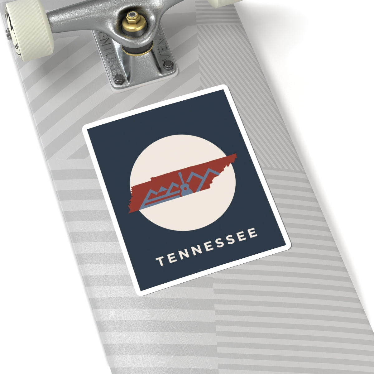 Tennessee outline sticker with retro mountains and guitar detail on a skateboard deck