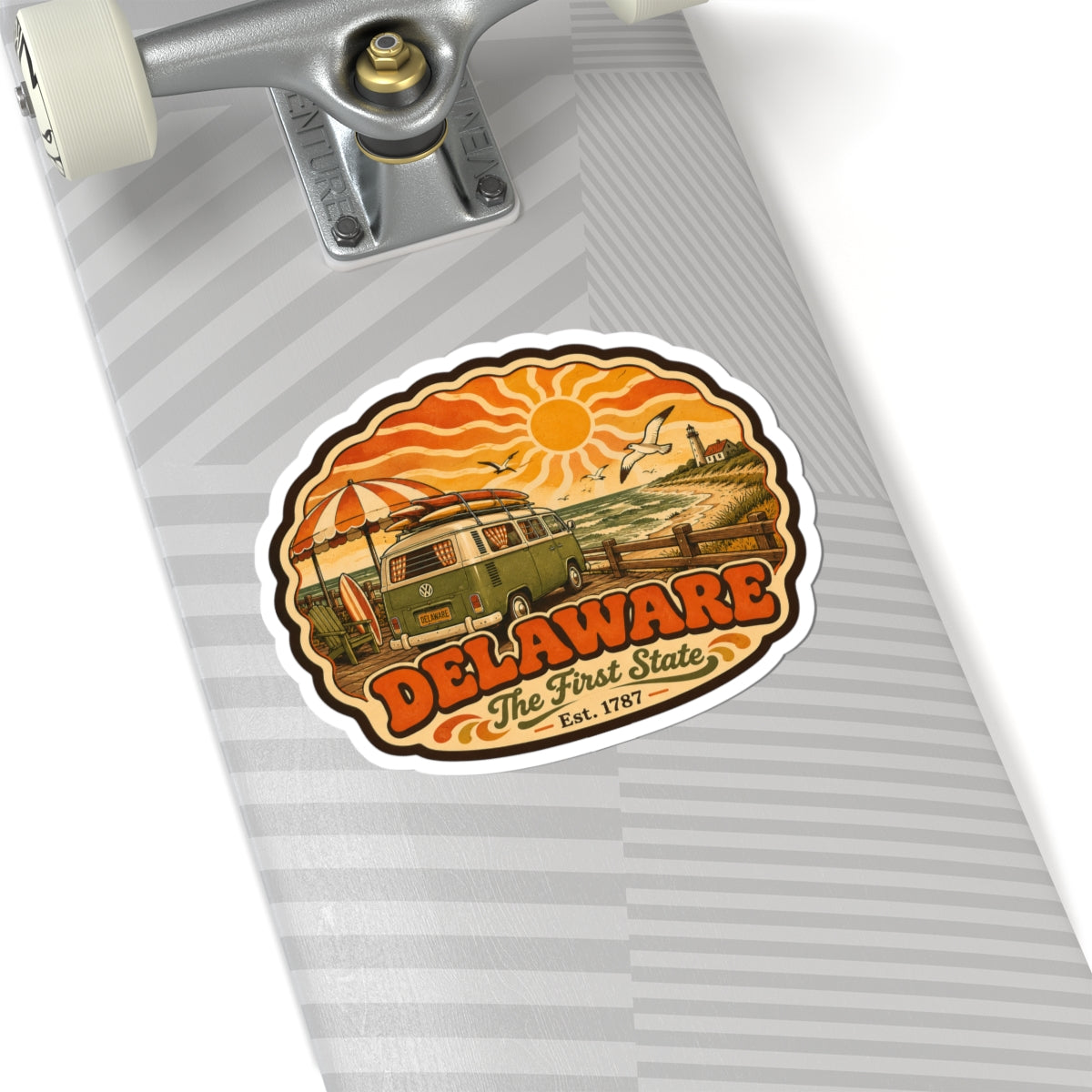 Oval Delaware sticker on light-gray skateboard deck, featuring vintage van and “Est. 1787”
