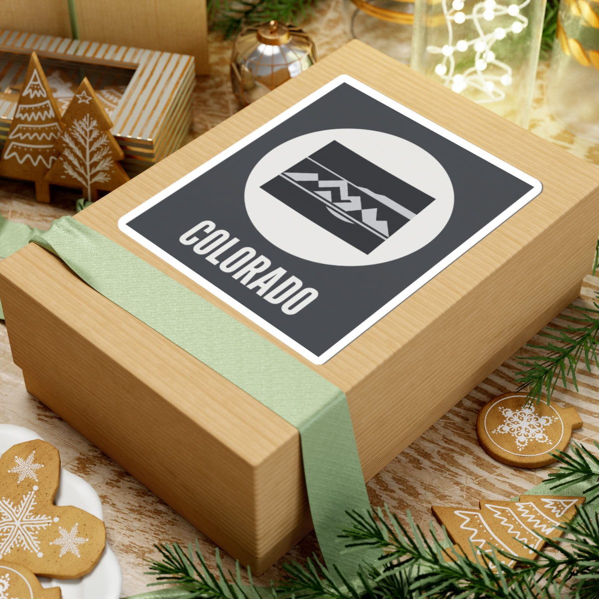 Colorado badge sticker with white circle mountain emblem, dark rectangle border, and COLORADO text