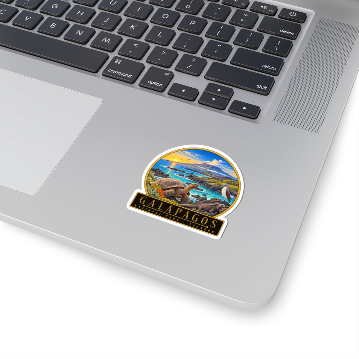 Vinyl sticker: circular Galapagos tortoise over ocean and volcanic landscape, on laptop