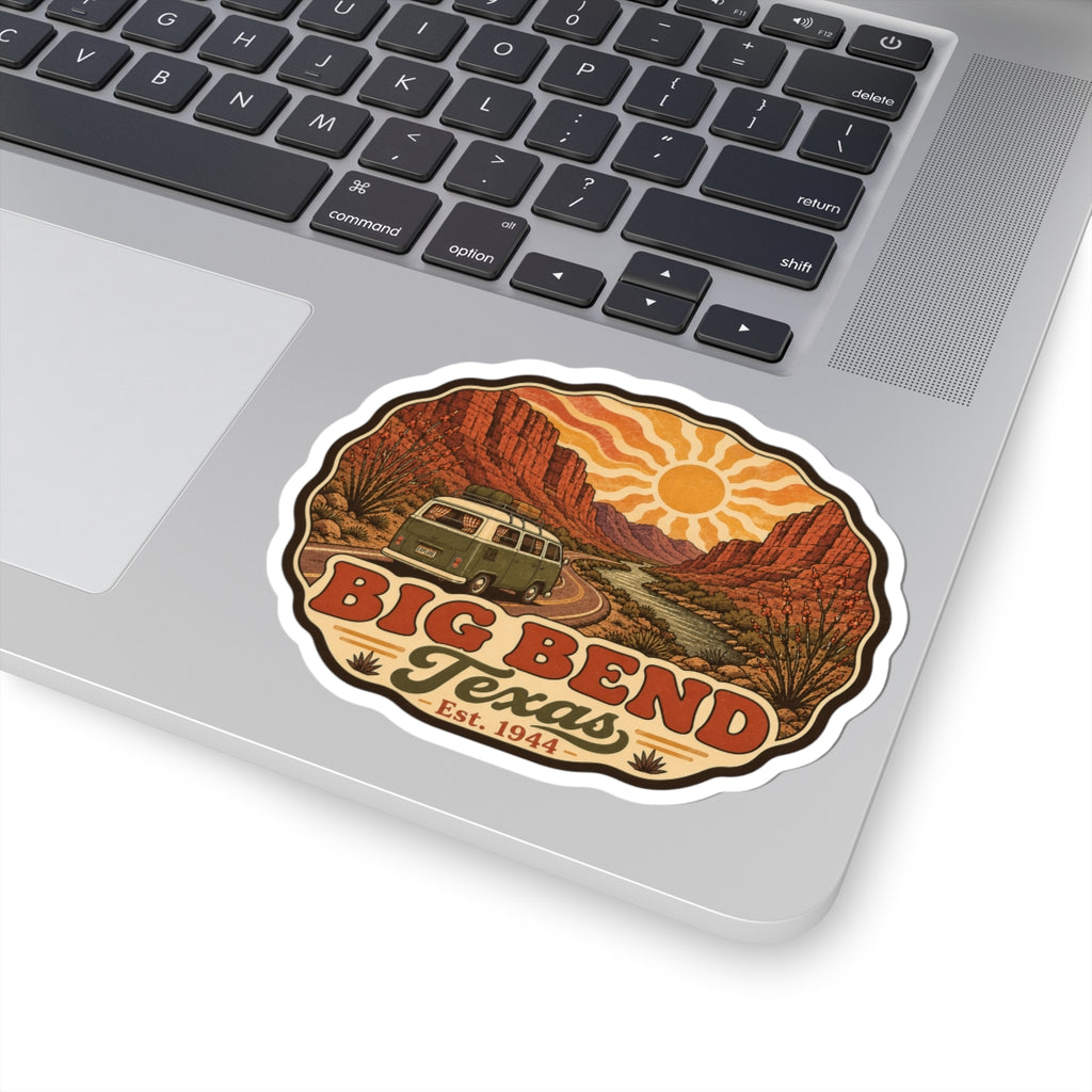 Die-cut Big Bend Texas sticker on a laptop keyboard with desert road and vintage camper artwork