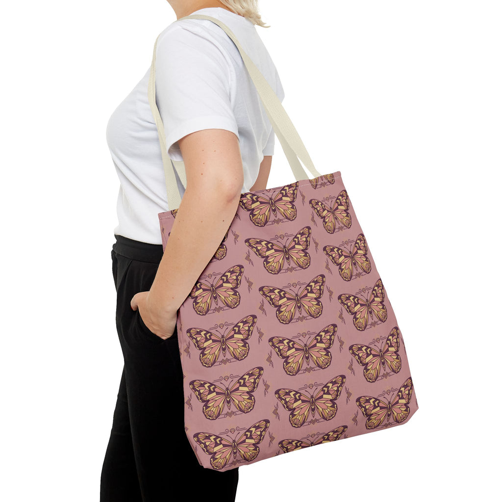 Pink butterfly tote bag with light beige strap, viewed from the back