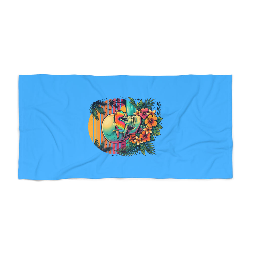 Blue beach towel with colorful skull and tropical floral graphic, rectangular