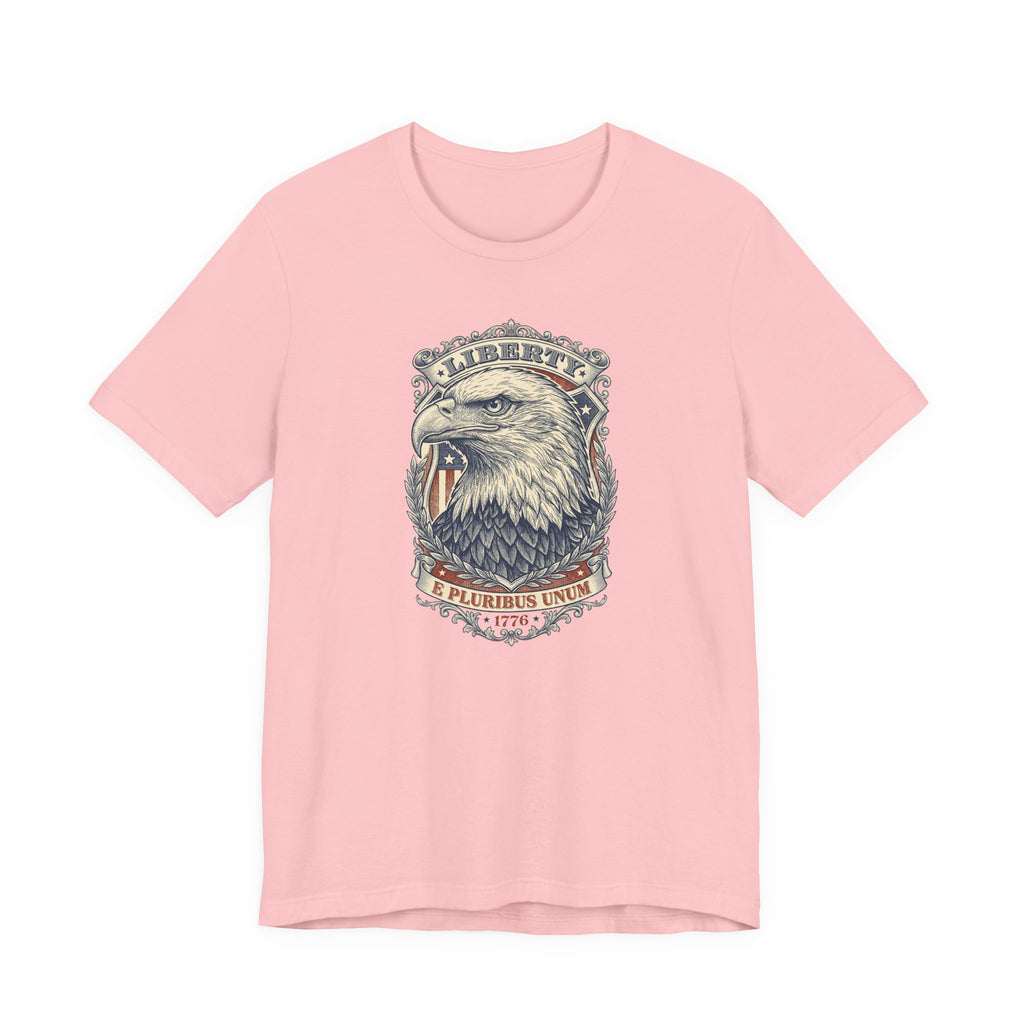 Pink crew-neck graphic tee with bald eagle head design and “E Pluribus Unum” text