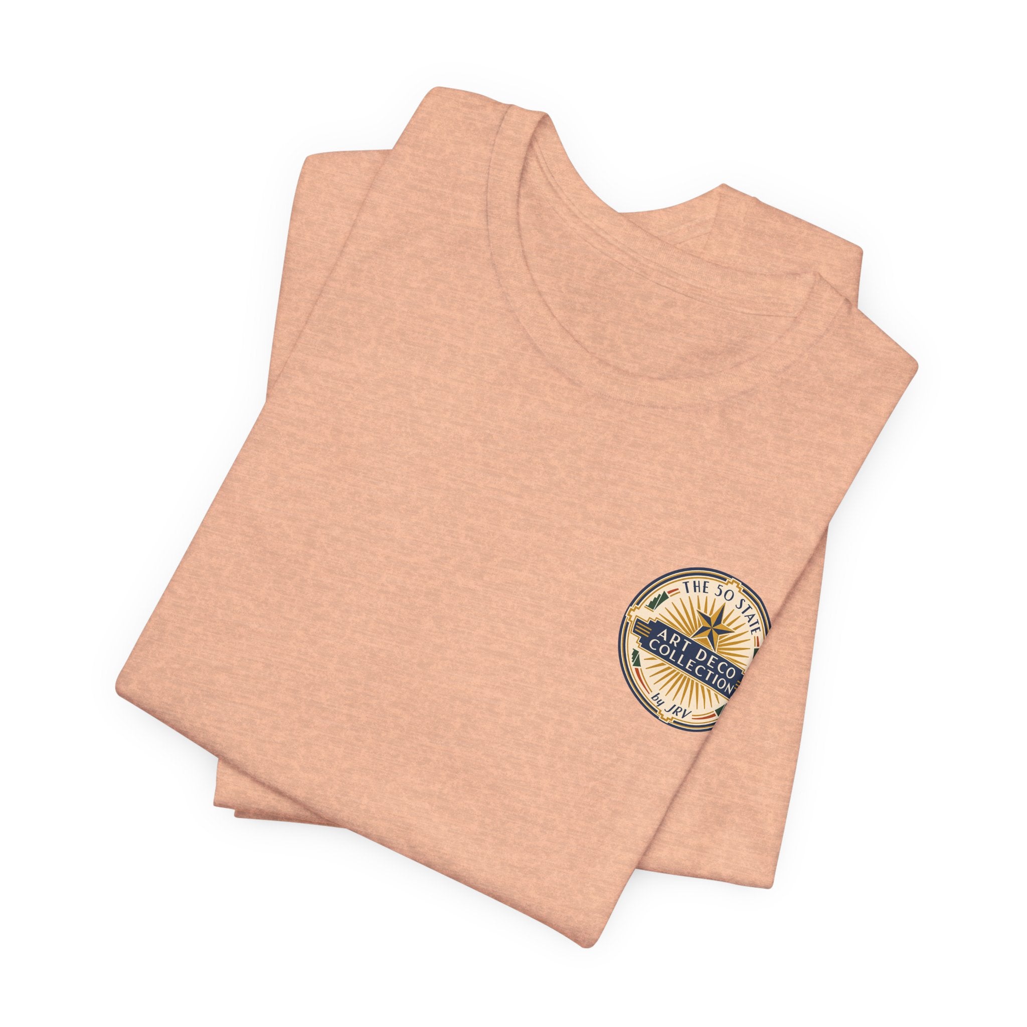 Peach T-shirt stack with small round Art Deco logo patch on chest