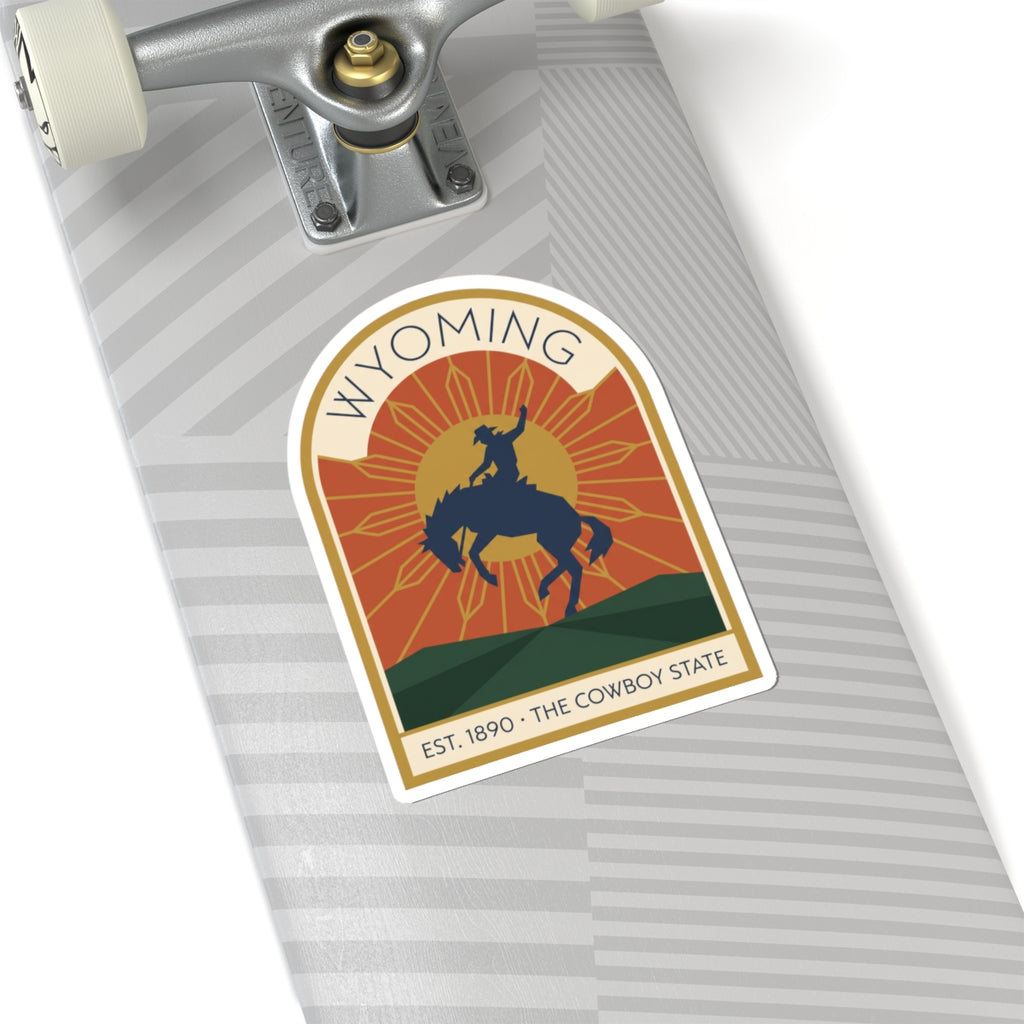 Arched vinyl sticker featuring cowboy on horseback with Wyoming text and Est. 1890