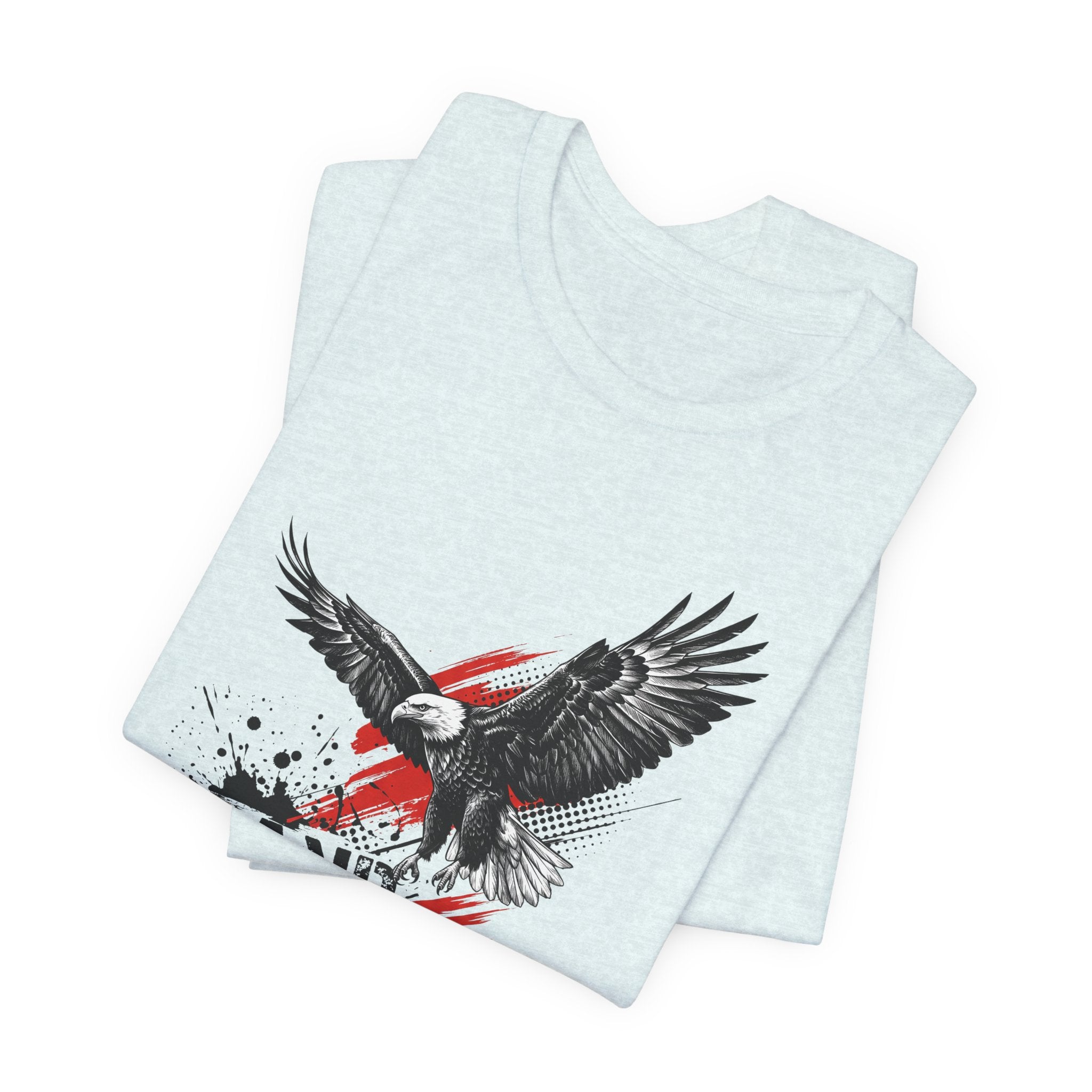Light blue graphic t-shirt with flying eagle over distressed red-white-blue splash design.