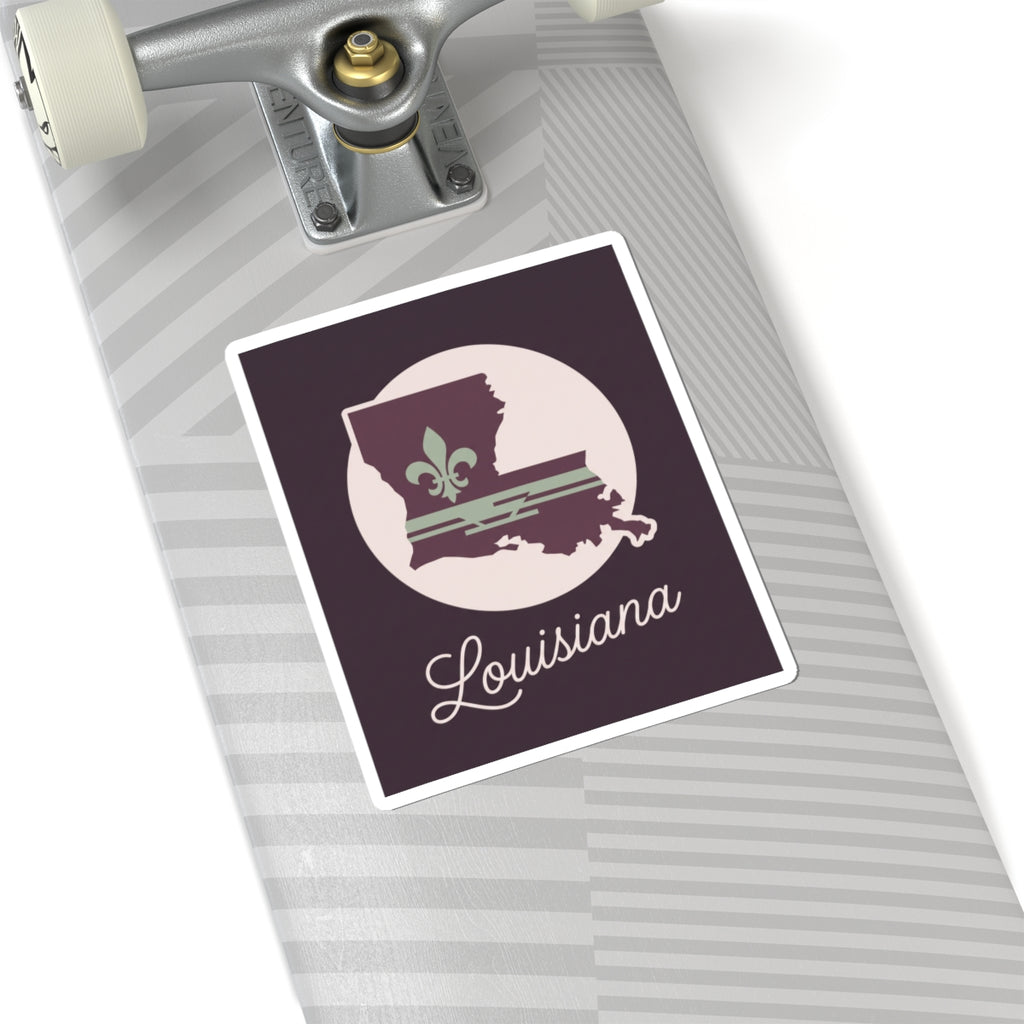 Louisiana silhouette vinyl sticker on suitcase surface, mauve design with white circle