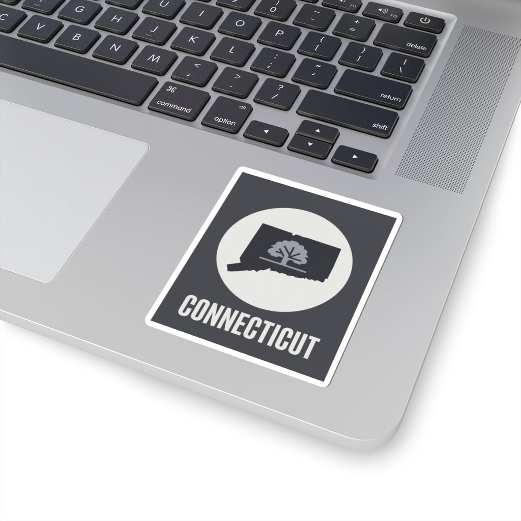 Connecticut state tree silhouette sticker on a laptop, dark square with white circle