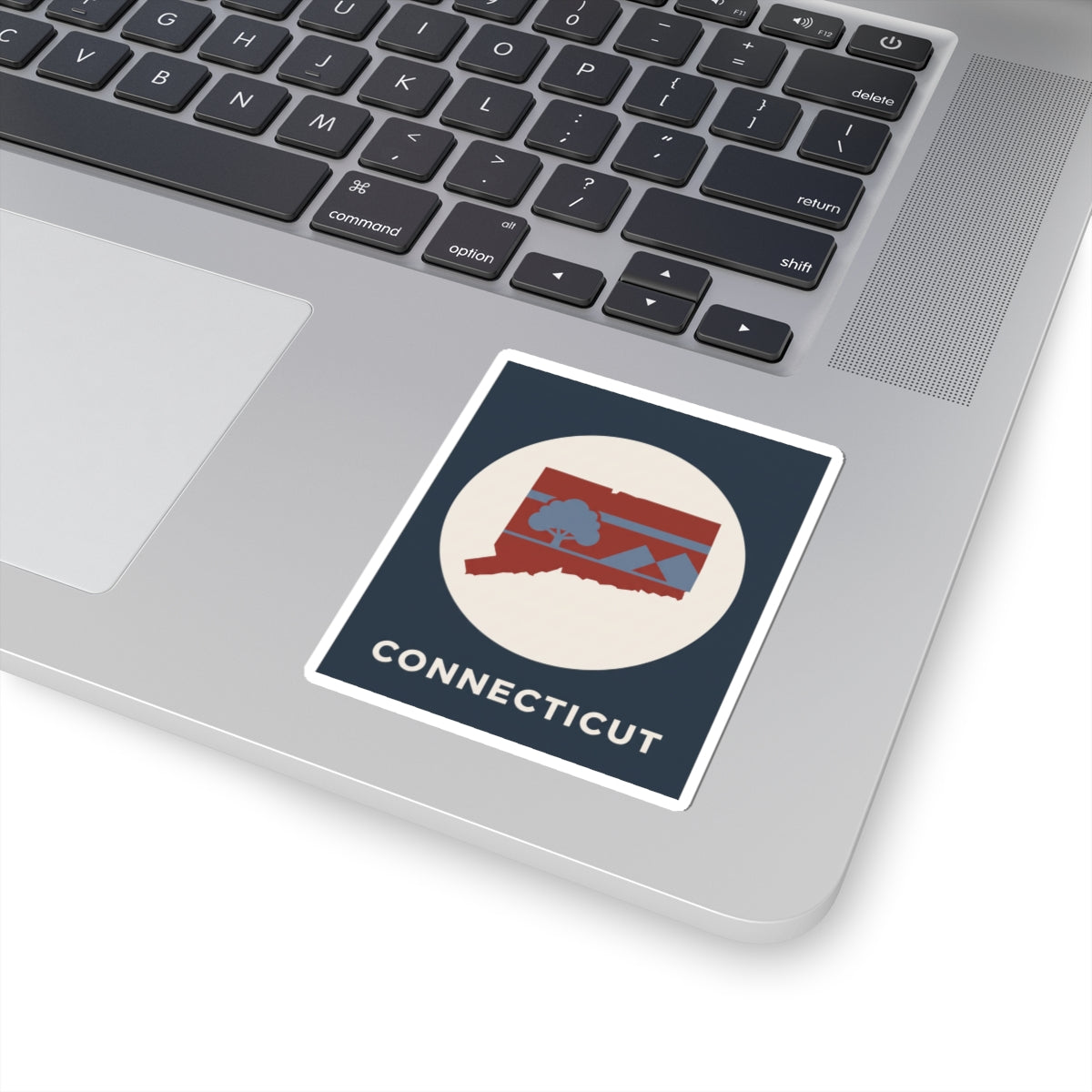 Connecticut state map sticker on laptop lid with retro circle and 'CONNECTICUT'