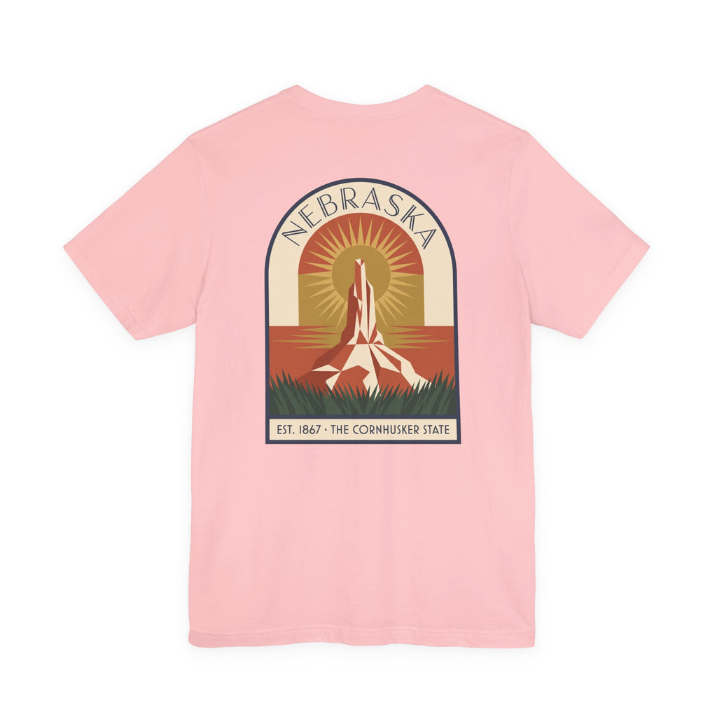 Light pink Nebraska graphic T-shirt with art deco tower and sunset badge