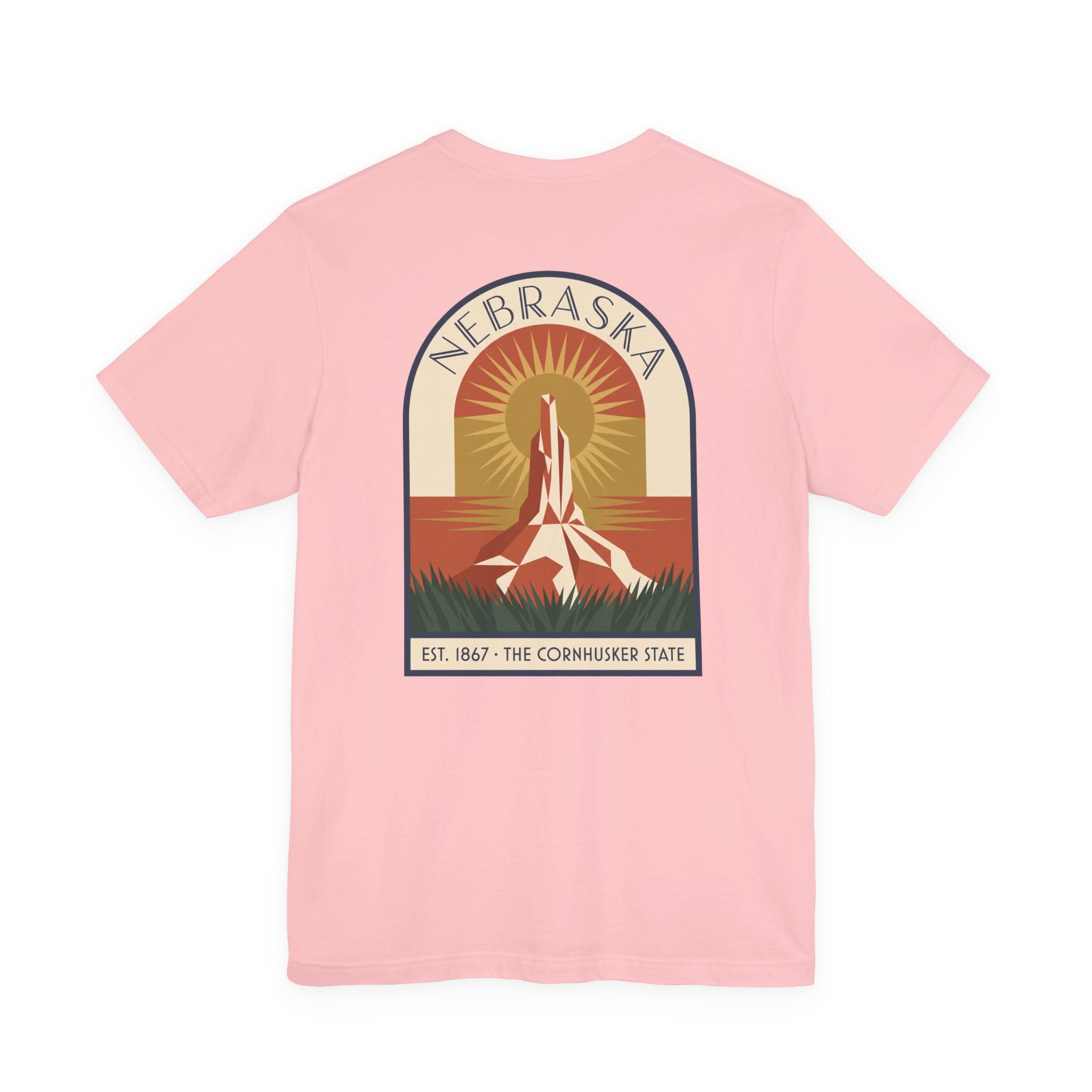 Light pink Nebraska graphic T-shirt with art deco tower and sunset badge